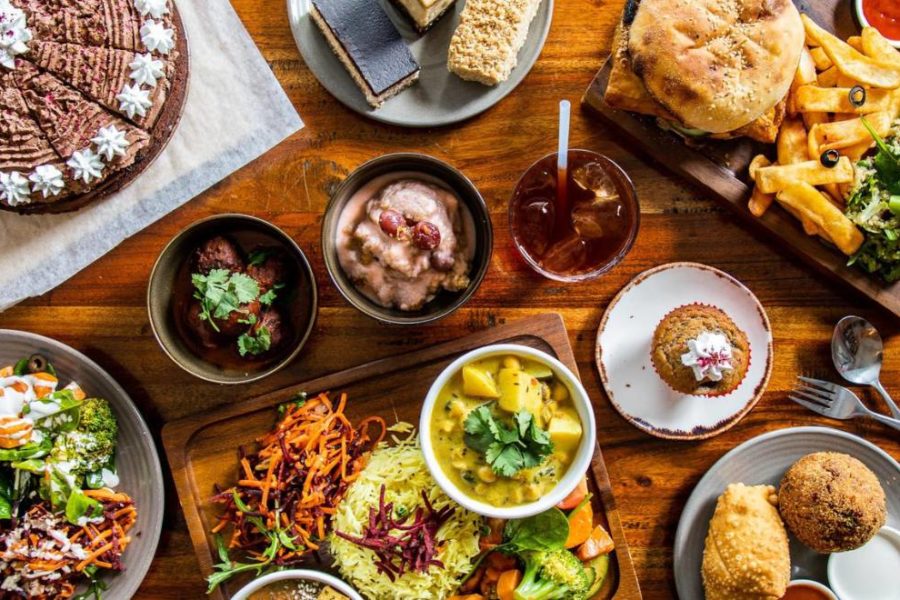 Plates of vegan food fills the table.